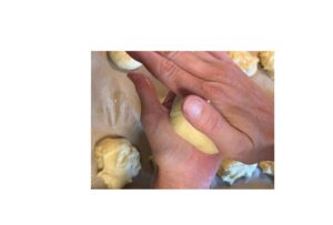 rolling bun dough to shape in palms of hands