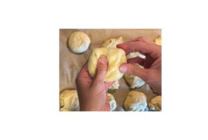 shaping bun dough in hands
