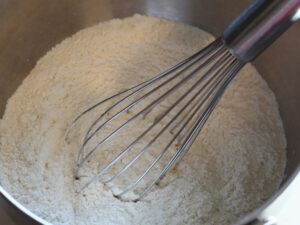 dry ingredients for dairy-free waffle recipe in bowl with whisk