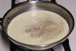 chicken broth and heavy whipping cream in saucepan with salt & pepper