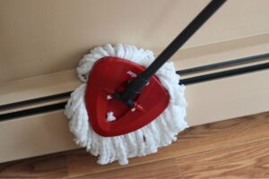 o-cedar mop cleaning baseboard with homemade natural floor cleaner