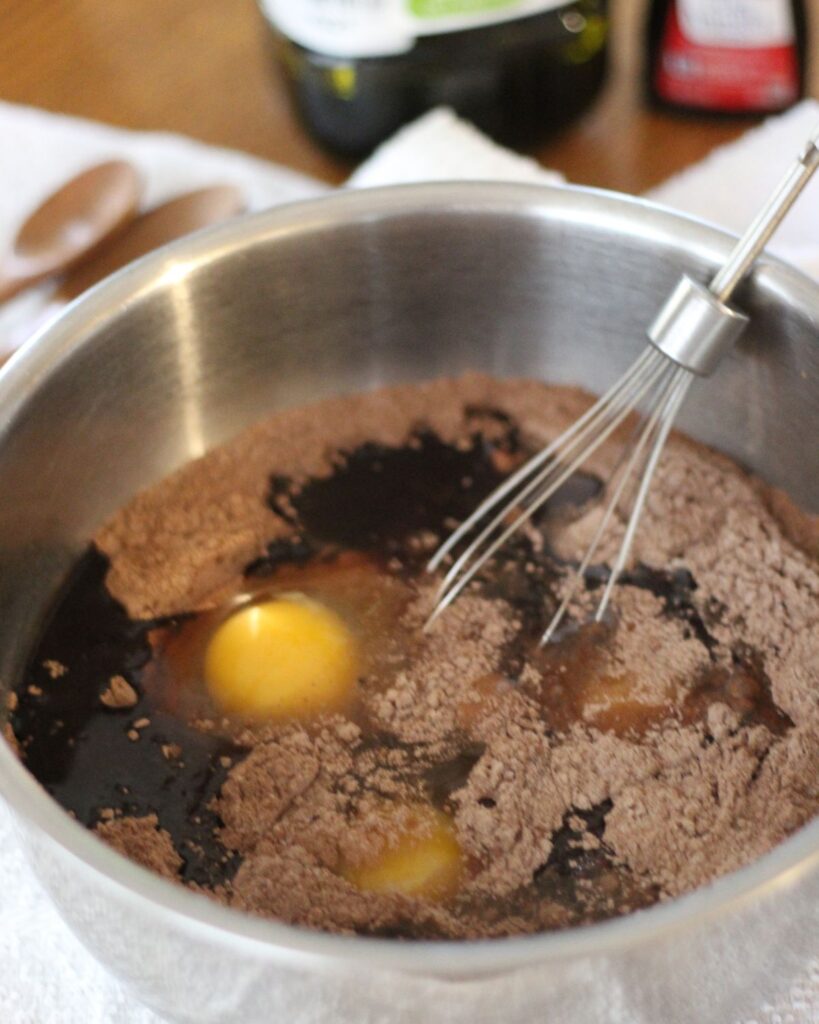 wet ingredients added on top of dry ingredients in mixing bowl