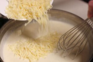 whisking in parmesan cheese