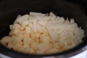 diced potatoes and onions in crockpot