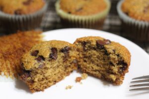 gluten free dairy free banana chocolate chip muffin split open on a plate