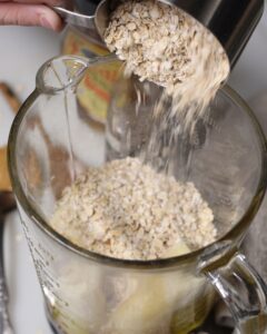 pouring gluten free quick oats into blender