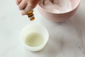 pouring essential oils into liquid castile soap