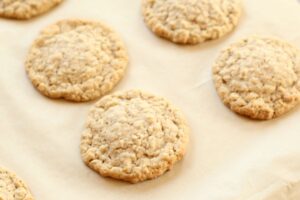iced oatmeal cookies fresh out of the oven with golden edges and slightly puffy