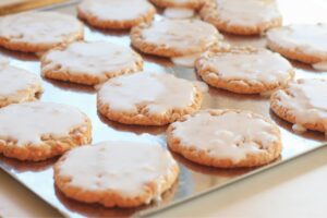 iced oatmeal cookies on a baking sheet