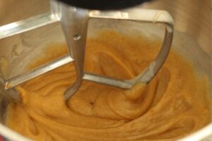 eggs, sugars, and oil mixed in bowl of stand mixer