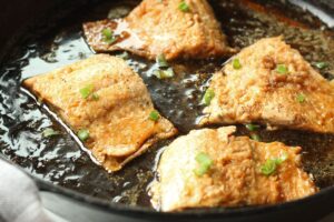 maple glazed salmon in cast iron pan