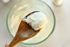 tub and sink baking soda scrub on a wooden spoon