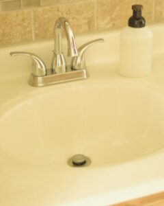 bathroom sink and soap dispenser