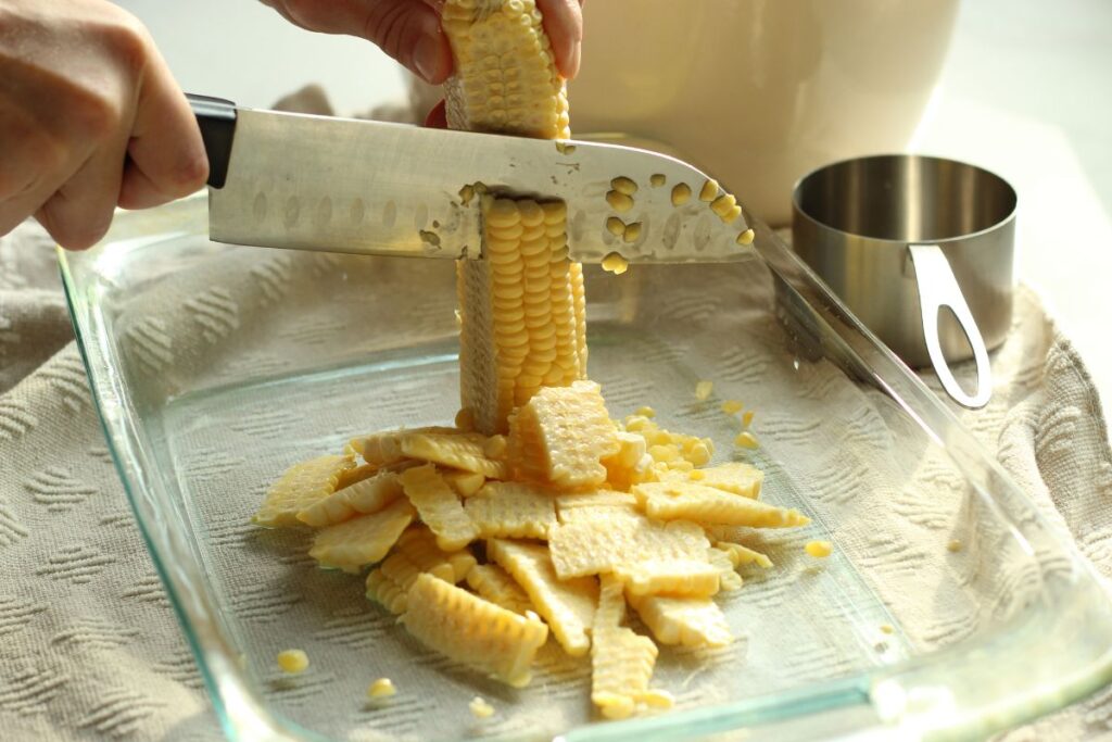 chopping sweet corn off the cob