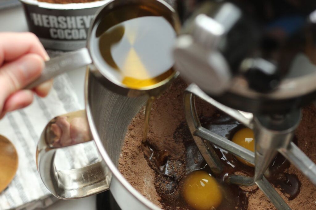 adding wet ingredients to dry ingredients in stand mixer