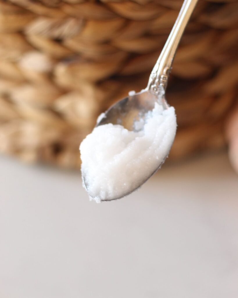 a scoop of coconut oil on a spoon