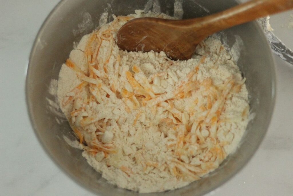 bowl of ingredients for homemade Red Lobster biscuits with a wooden spoon