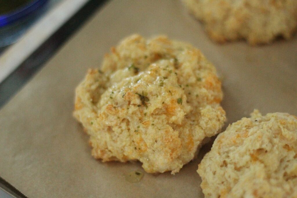 close up of a homemade Red Lobster biscuit on baking sheet