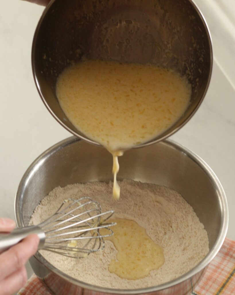 pouring wet ingredients into dry ingredients