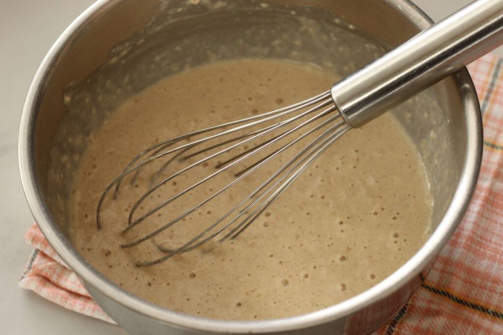 bowl of mixed mini pancake muffin batter with whisk