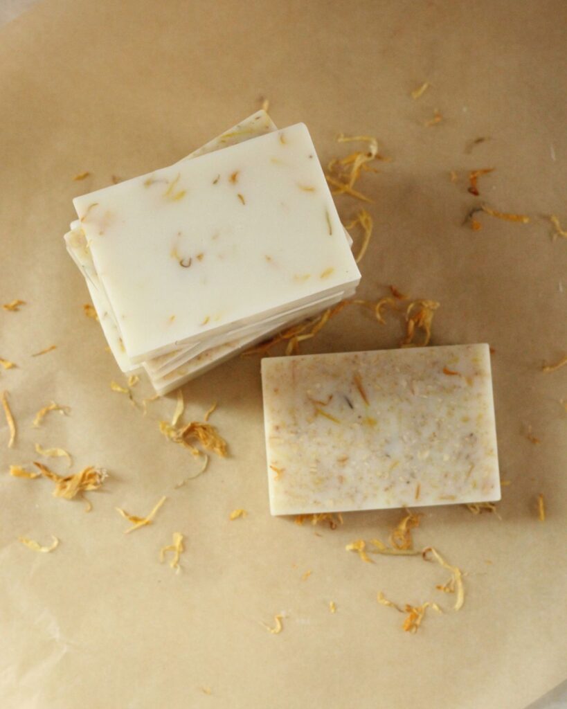 garden hands soap bars on parchment paper with calendula petals scattered around