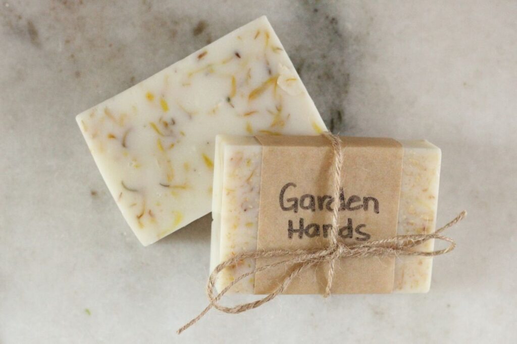 2 bars of garden hands soap. 1 wrapped in parchment paper and twine.