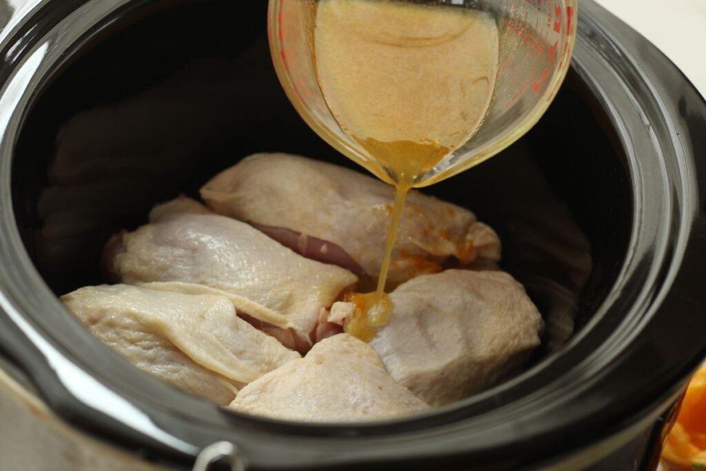 pour citrus & herb glaze over chicken thighs in slow cooker