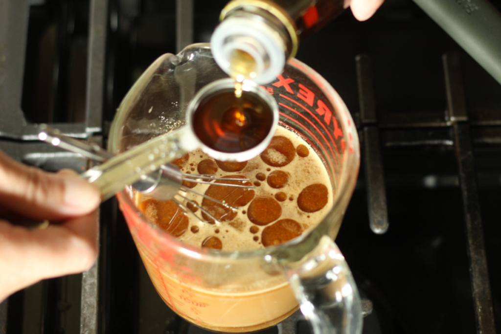 measuring sesame oil to add into sauce ingredients