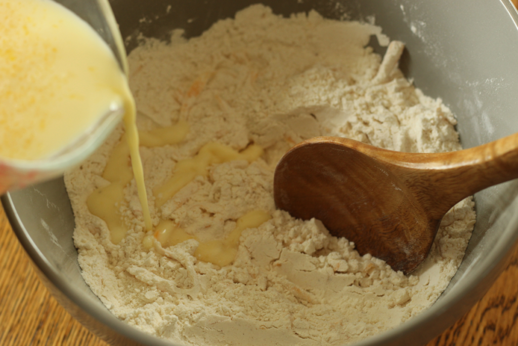 adding liquid ingredients to dry ingredients